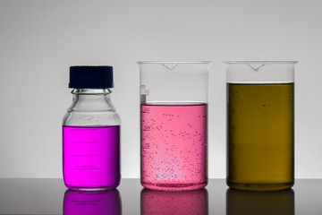 Liquid in laboratory bottles. Scientific biochemical laboratory. Colorful liquid.