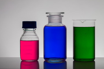 Liquid in laboratory bottles. Scientific biochemical laboratory. Colorful liquid.