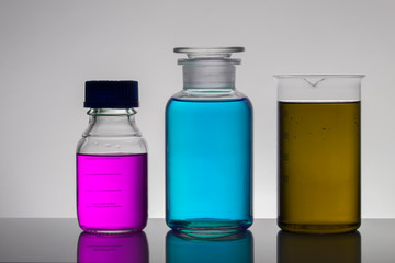 Liquid in laboratory bottles. Scientific biochemical laboratory. Colorful liquid.