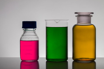 Liquid in laboratory bottles. Scientific biochemical laboratory. Colorful liquid.