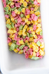 Top view on colorful candied fruit in a white tray