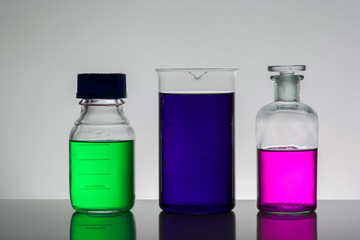 Liquid in laboratory bottles. Scientific biochemical laboratory. Colorful liquid.