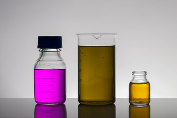 Liquid in laboratory bottles. Scientific biochemical laboratory. Colorful liquid.