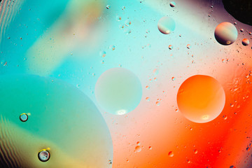 Abstract background with colors. Distortion in water with oil droplets. Bright abstraction, ultraviolet. Circles on the water.