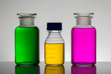 Liquid in laboratory bottles. Scientific biochemical laboratory. Colorful liquid.