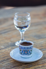 a сup of black coffee and a glass of clean water