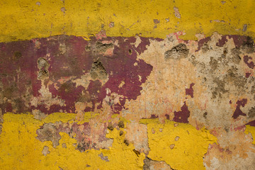 yellow red old concrete wall with severe damage and scratches. rough surface texture