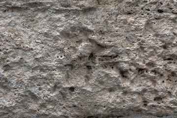 Textured uneven stone surface. Yellow limestone. Background image. Construction material.