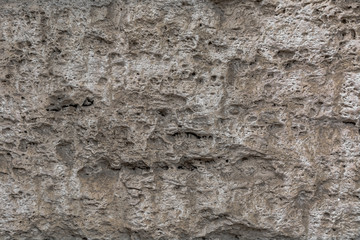 Textured uneven stone surface. Yellow limestone. Background image. Construction material.