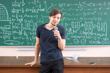 happy student portrait in front of blackboard b