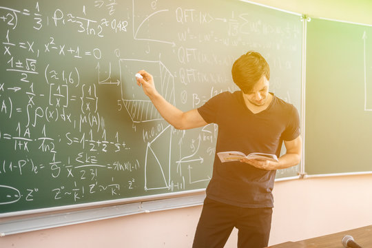 pupil doing homework on blackboard b