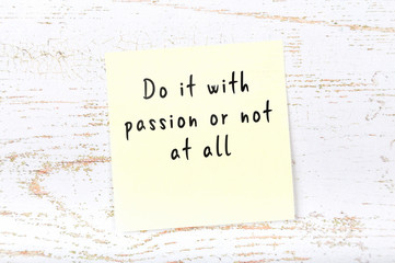 Positive inspiring quote handwritten on sticky note on wooden background