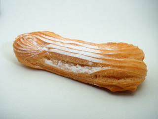 Eclair cake sprinkled with powdered sugar on a white background.