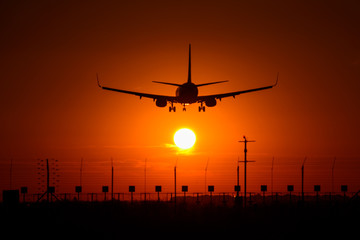 Fototapeta na wymiar Silhouette of airplane in the sunset 