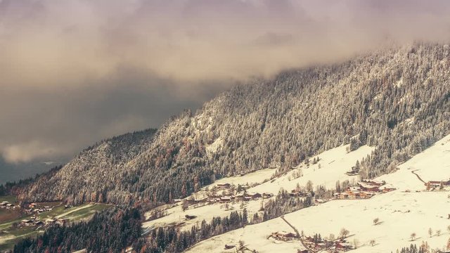Mountains in the Austrian Alps gradually turn from summer to winter in a smooth transition.