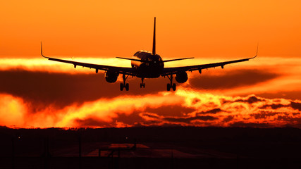 airplane landing at sunset