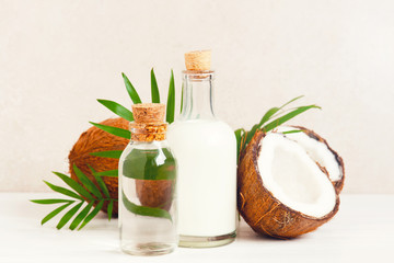 Coconut milk and water in the glass bottles on the white table