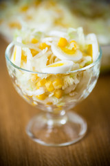 Fresh Peking cabbage salad with boiled eggs, canned corn