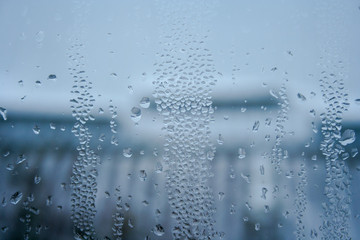 Naklejka na ściany i meble Background with water drops on the glass. Water vapor on the window