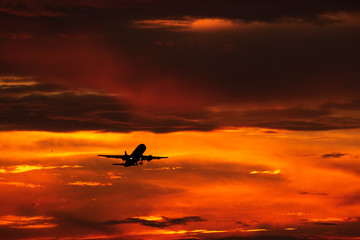 Silhouette of airplane taking of in the sunset 