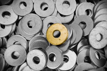 steel ring circle, many metal shining and one gold washers background.