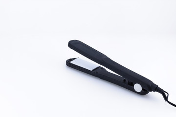 Grey hair iron on the white background with copy space.