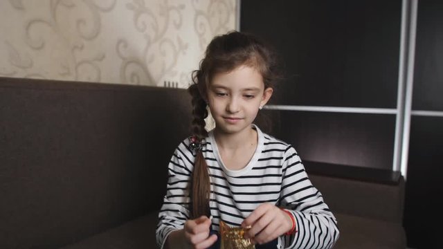 The little girl puts the tooth in a baggie for the tooth fairy.