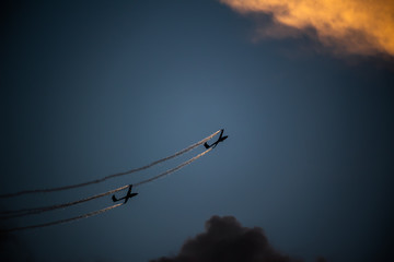 Airplane silhouette in the sky at sunset time during air show BIAS , Bucharest , Romania  