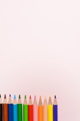 Back to school concept - school office supplies. Top view of wooden office table with colorful supplies and copy space. Design and art concept