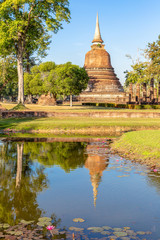 Fototapeta na wymiar pond against stupa in the Historical Park of Sukhothai, Thailand, Asia