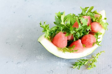 Fresh Juicy Watermelon arugula salad with mint with soy sauce and  lemon juice. summer dish, healthy food, copy space