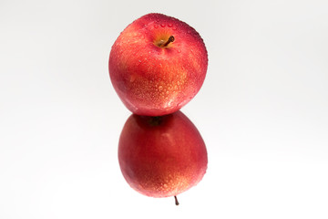 Red Apple isolated on white background with reflection. Fresh raw organic fruit.