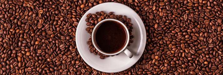 Cup of coffee on a background of coffee beans