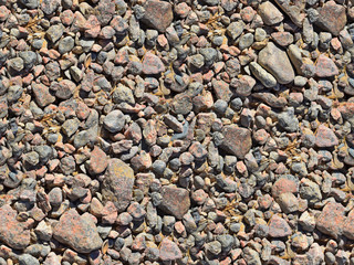 seamless texture, surface of small stones gray-brown, pebble, macro