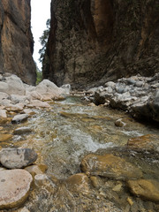 Crystal clear water of a cold mountain creek at rocky terrain of Samaria gorge, south west part of...