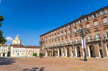 Fototapeta premium Prefecture Palazzo del Governo Palace buildings and San Lorenzo Saint Lawrence church on Castle Square Piazza Castello in historical centre of Turin Torino city with clear blue sky, Piedmont, Italy