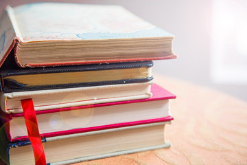 books sitting on table with lens flare effect. good for high school college and university students seeking knowledge and creative concepts. 