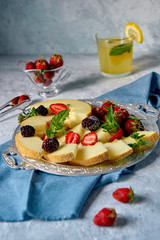 Tray with fruit and berries and lemonade