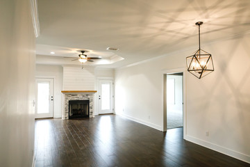 Modern Open Spacious Living Room With Tiled Fireplace and Custom Mantle and Dark Wood Floors