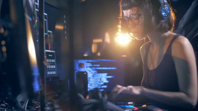 Female hacker cracking system, close up.
