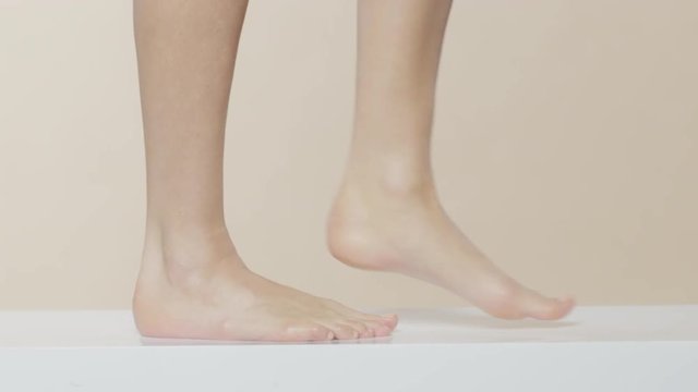 Female feet walking on a white surface, recorded Red Monstro and using Briese Focus 140 HMI.