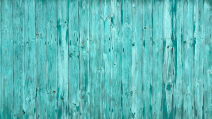 The old wooden walls painted green. Old wooden wall background or texture.