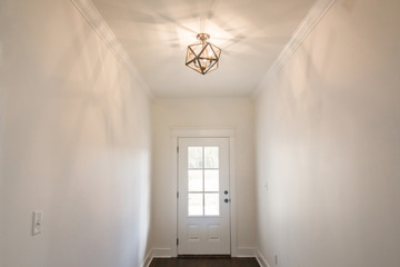 Modern new Construction Foyer front Entryway with Custom Lighting