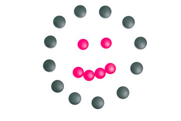 green and pink pills on white background