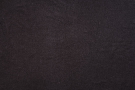 Old t-shirt texture, dark blue stretch fabric background. Analog photo simulation
