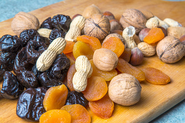 vegetarian food of nuts and dried fruits on the kitchen board