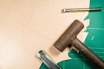 Leather craft tools on desk.