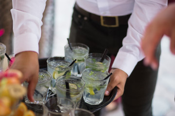 Mojito healthy ice cube Cocktail drink with burning cinnamon and lime, mint beverage on a bar counter. Selective focus. Top view. Trendy stylish edit. Copy paste space design service barman waiter