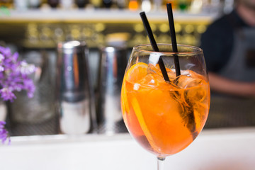 Orange Aperol spritz Cocktail drink -beverage on a bar counter .  Selective focus on the foreground glass, Top view . Trendy stylish edit . Copy paste space for design concept service barman concept