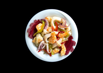 Fresh seafood isolated on dark vintage background with vegetables in plate from top view